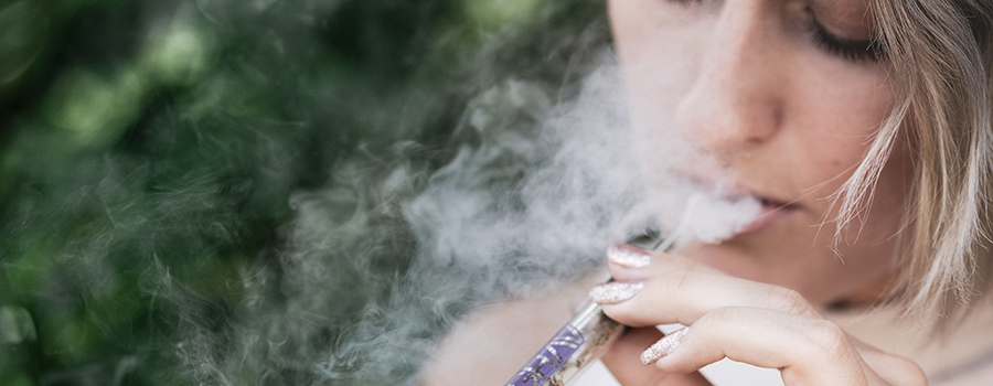 Woman smoking CBD oil from a glass pipe. Medical marijuana dispensary marketing plan. Cannabis marketing agency Canada and USA. 420Digital.ca.
