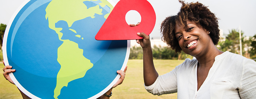 Afro american woman holding a Google place pin towards a globe. MMJ SEO company. Medical marijuana marketing and seo services. 420Digital.ca cannabis marketing in Canada and USA.